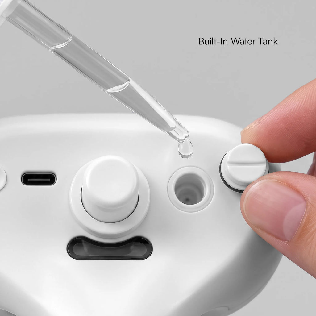 White mist grooming brush with built-in water tank and molded fill controls