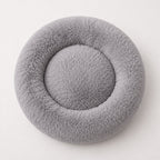 Gray donut-shaped pet bed with circular center nest