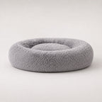 Gray plush donut-shaped pet bed with thick raised outer rim