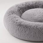 Close-up of gray plush donut pet bed rim and inner cushion texture