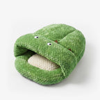 Green plush cave toy with stitched opening and white button eyes