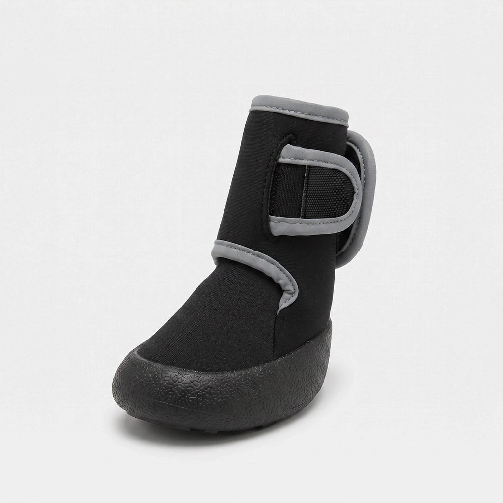 A single black ankle boot with gray trim and a hook-and-loop strap closure, shown from a three-quarters angle on a light gray background.
