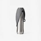 Stainless steel insulated bottle with gray sleeve, black spout cover, and loop handle