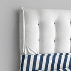 White tufted support panel with navy-and-white striped pet bed section