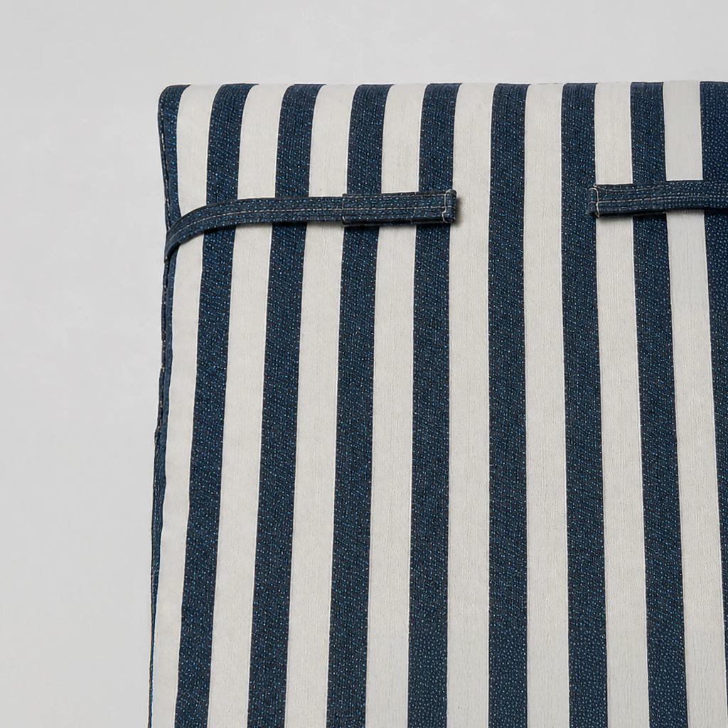 Navy-and-white striped dog bed front with blue side strap detail