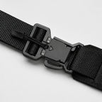 Close-up of black belt strap with plastic buckle and metal snap hardware