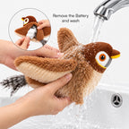 Plush bird toy with hands rinsing under water from a tap